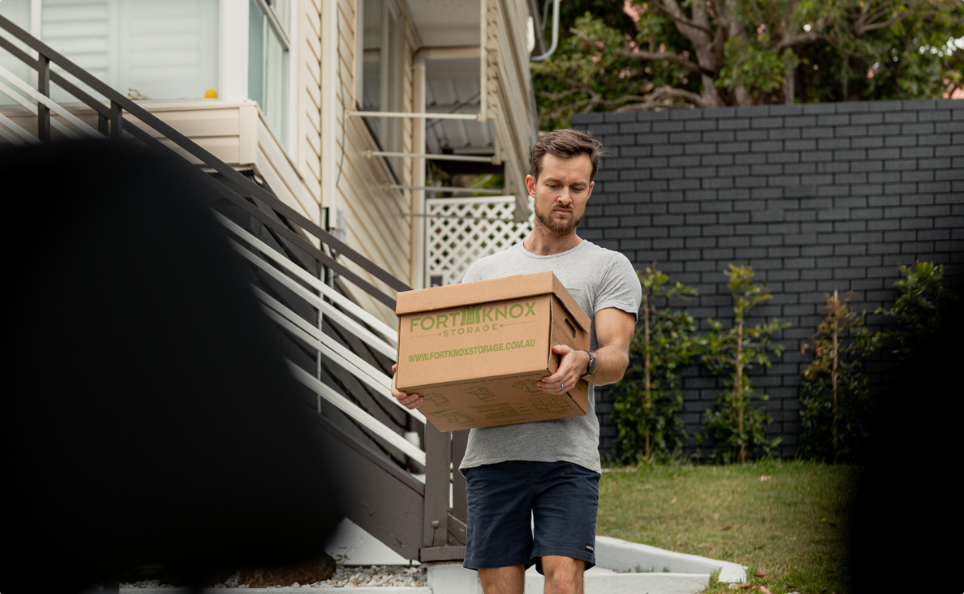Person carrying a Fort Knox Storage box