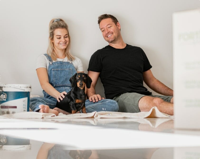 People sat on the floor with a dog