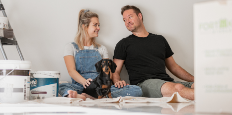 People sat on the floor with a dog