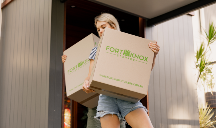 People carrying Fort Knox Storage boxes