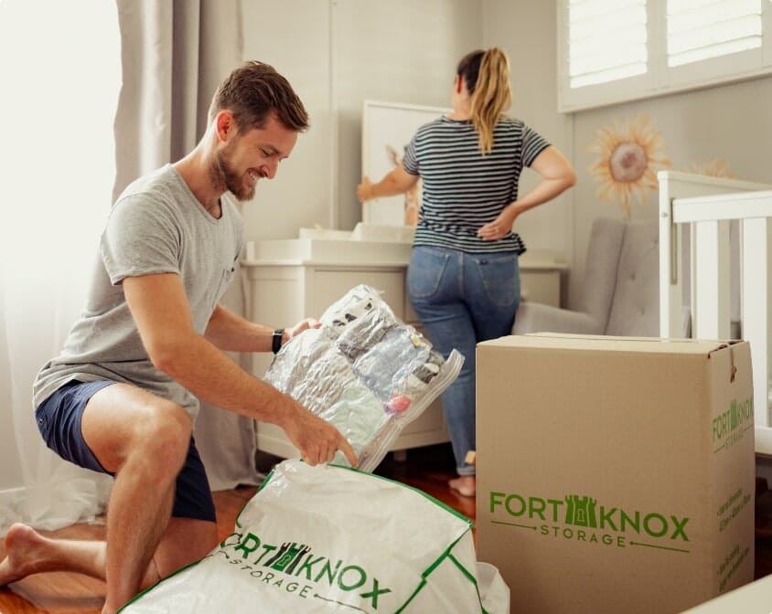 People packing items into a Fort Knox Storage box