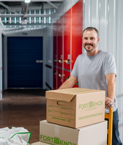 Person using a trolley to move Fort Knox Storage boxes