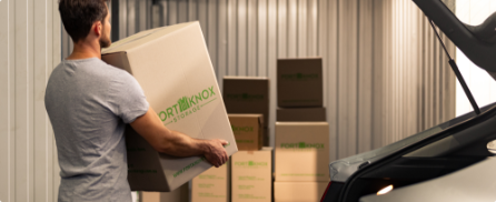 Person carrying a Fort Knox Storage box