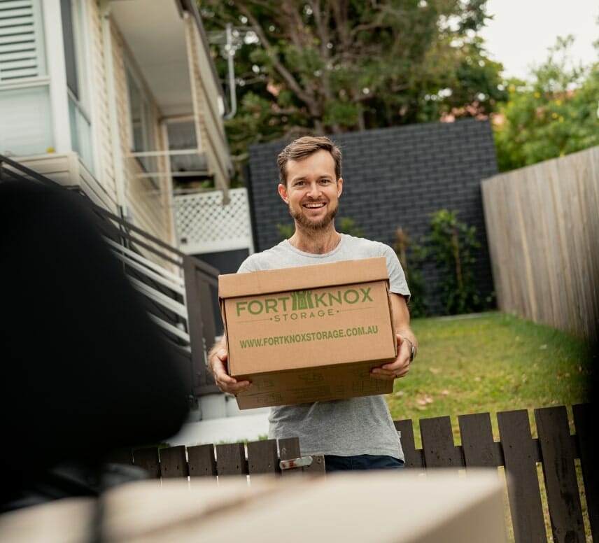 A person carrying a Fort Knox Storage box