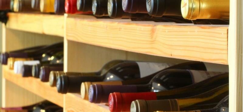 Wine bottles on a storing rack