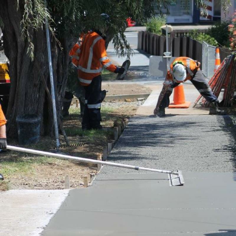 People concreting a footpath