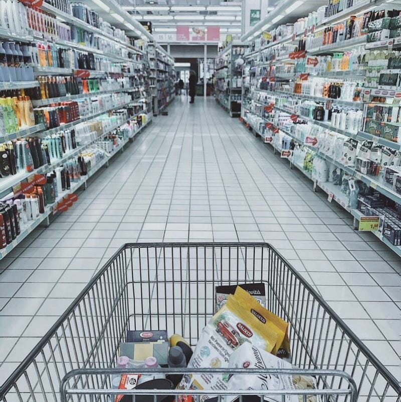 A shopping cart in a store aisle